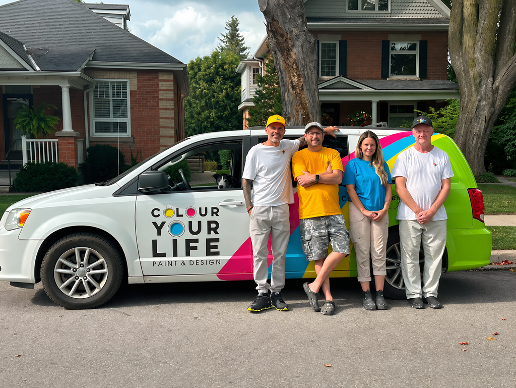 The Colour Your Life painting crew of five standing together beside the company's branded van