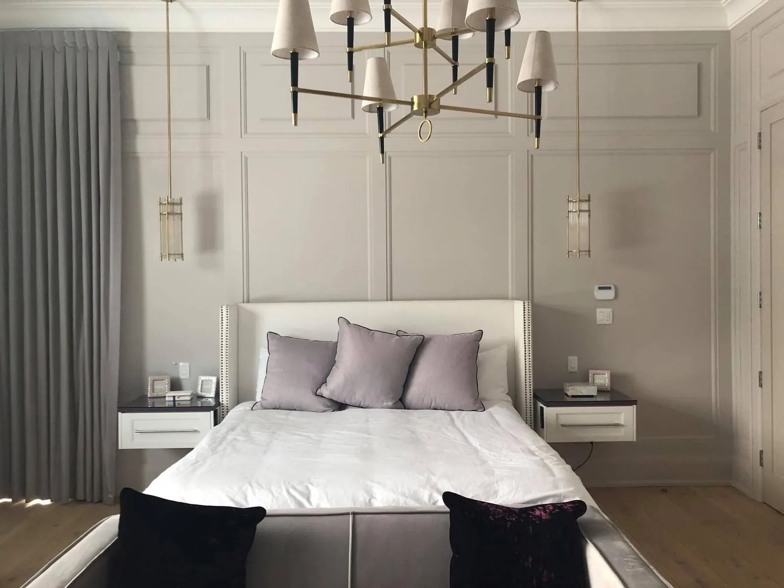 Bedroom with a panelled feature wall and tall drapes
