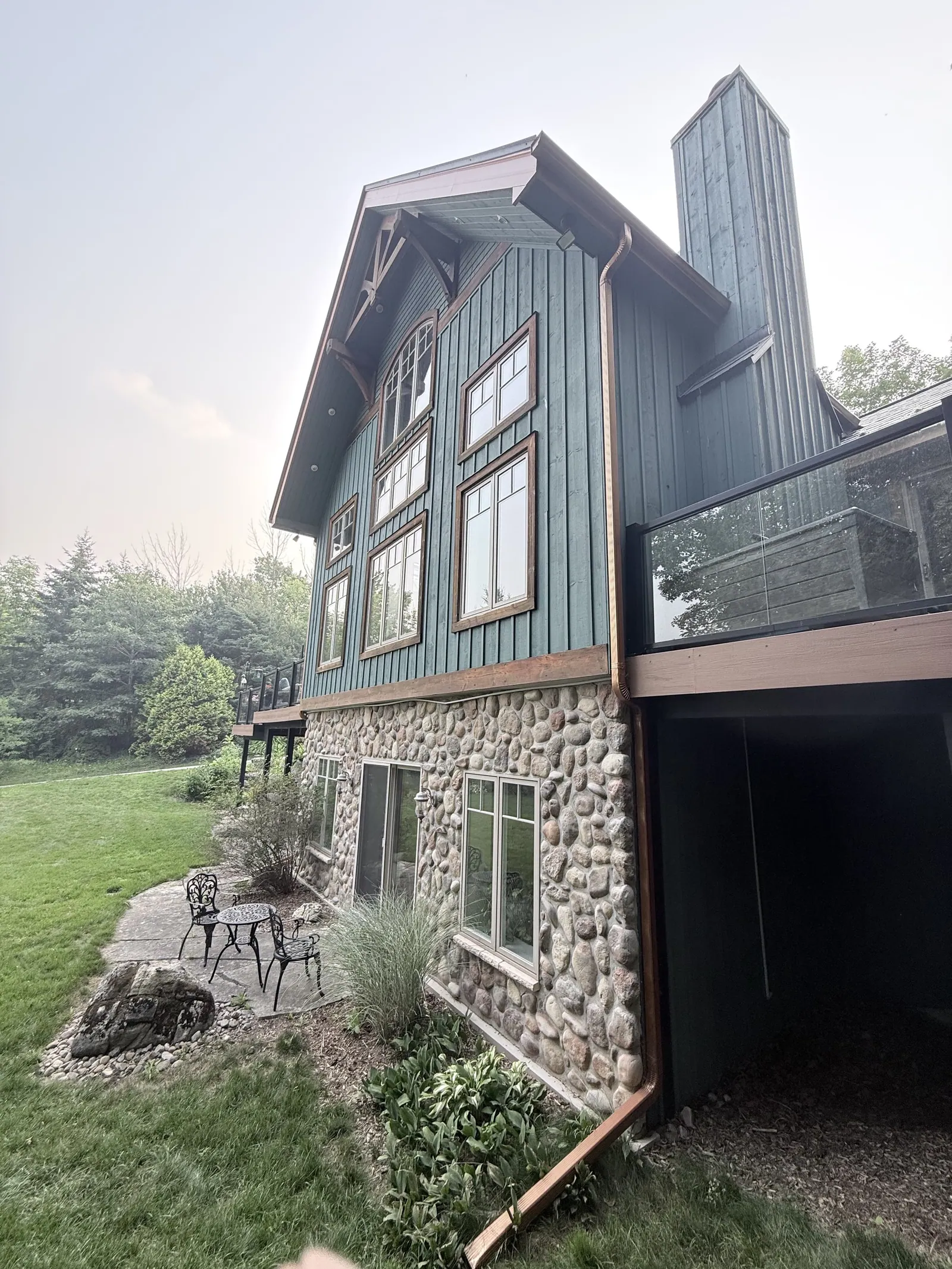 Blue siding and a stone base on a multi-level home