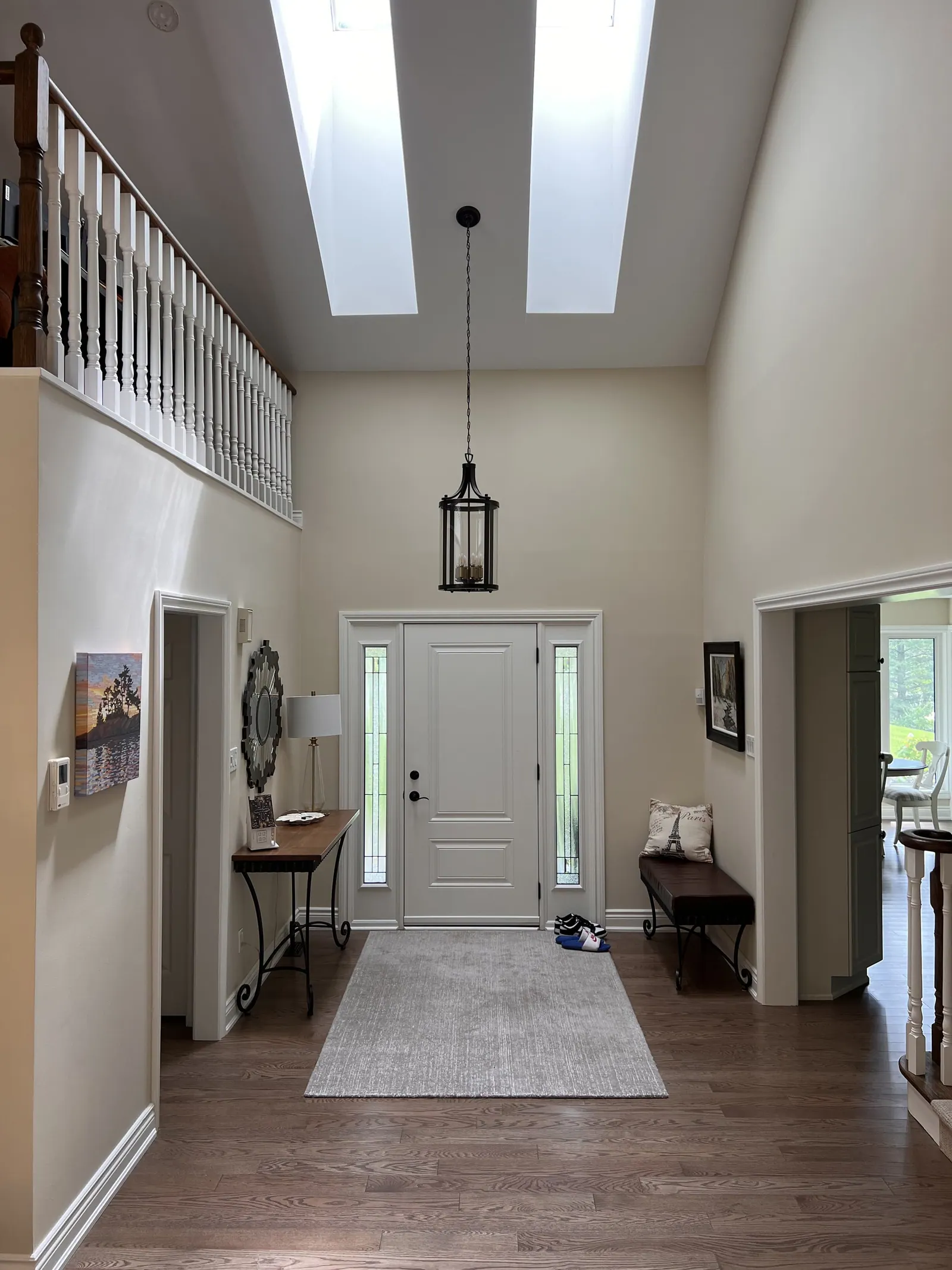Bright entry hall with a lantern pendant and white walls