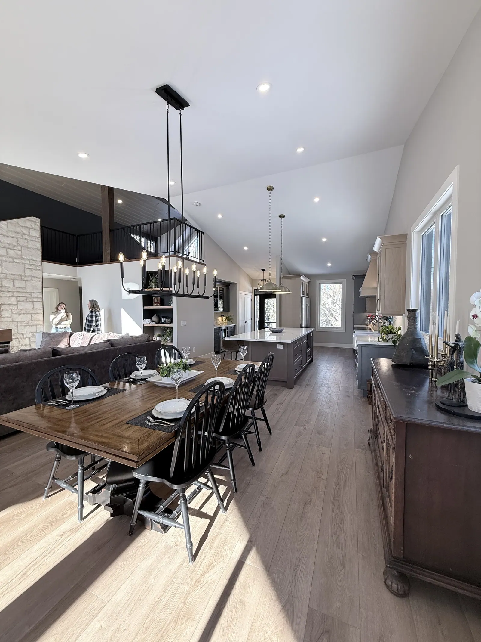 Dining area and kitchen under a vaulted ceiling