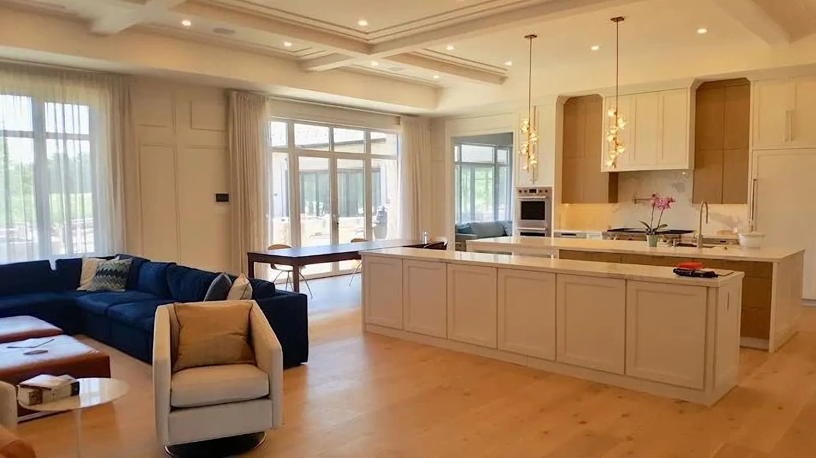 Kitchen with a coffered ceiling, cream cabinets and a long island