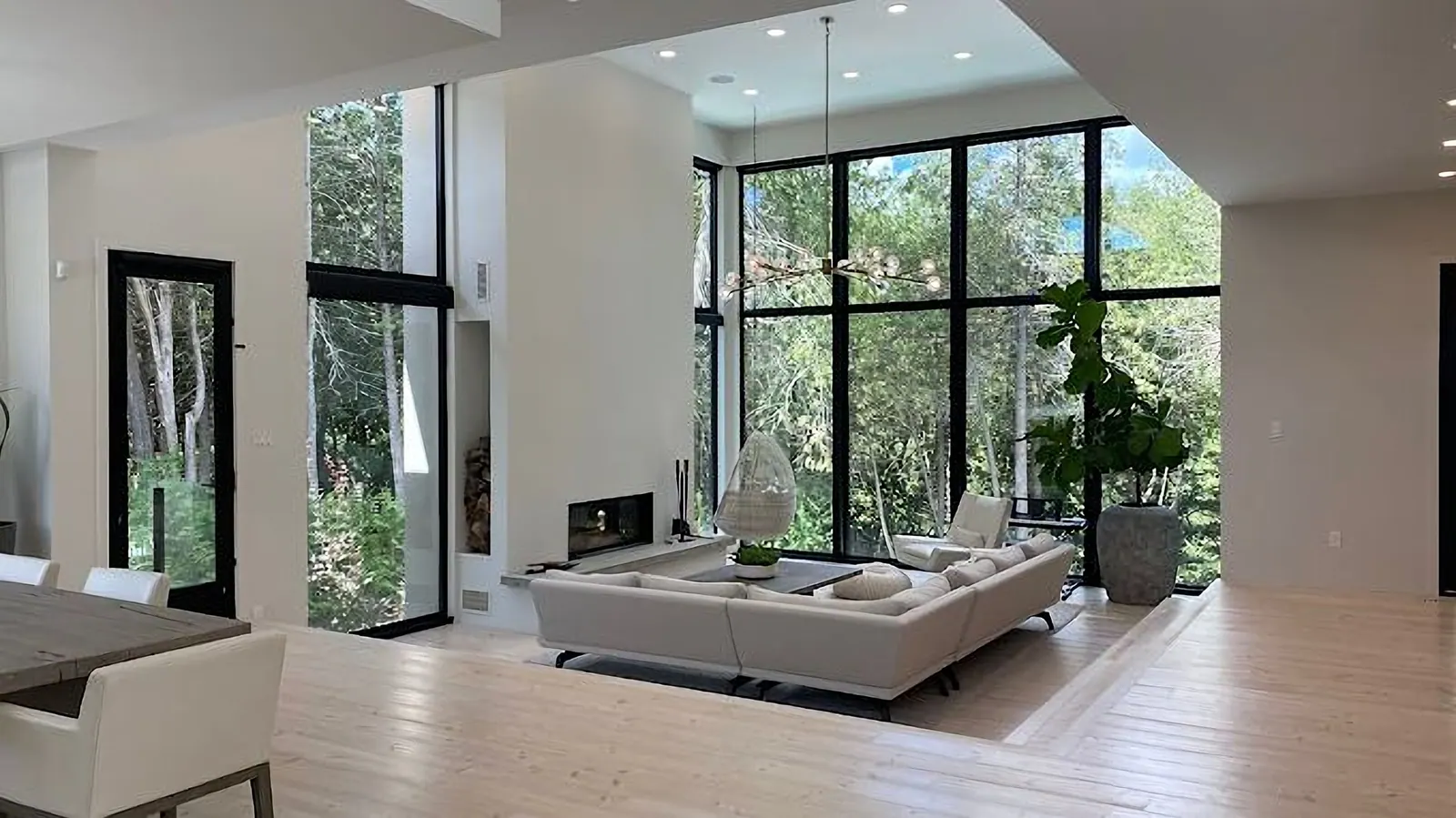 Freshly painted living room with a two-storey wall of windows