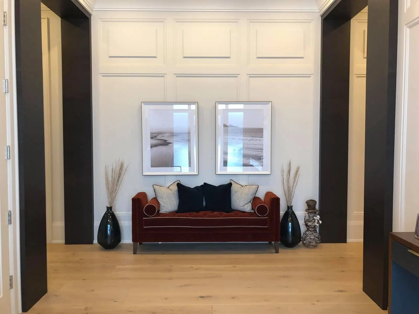 Panelled alcove with a bench and framed prints