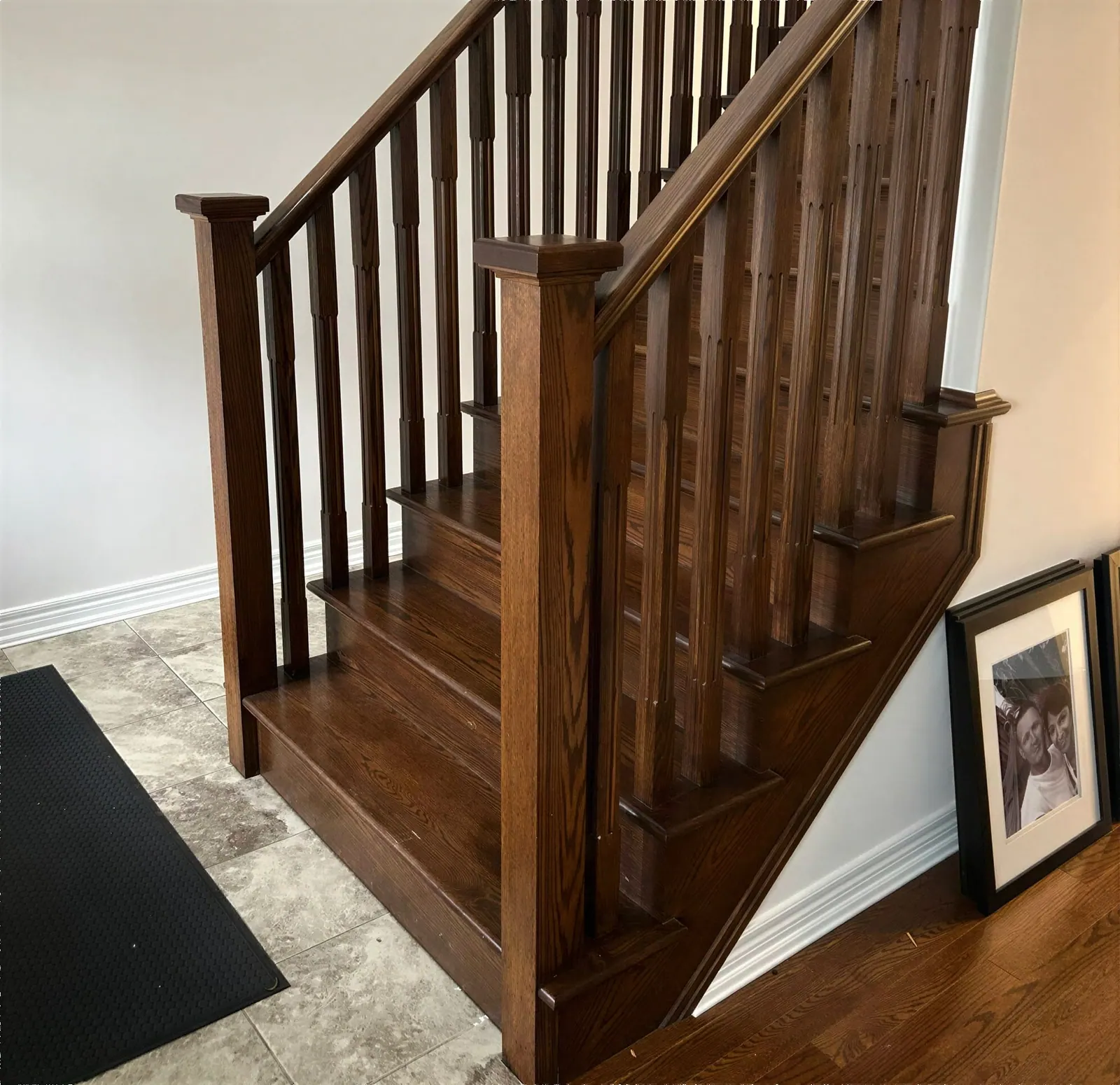 Stained wood staircase beside freshly painted walls