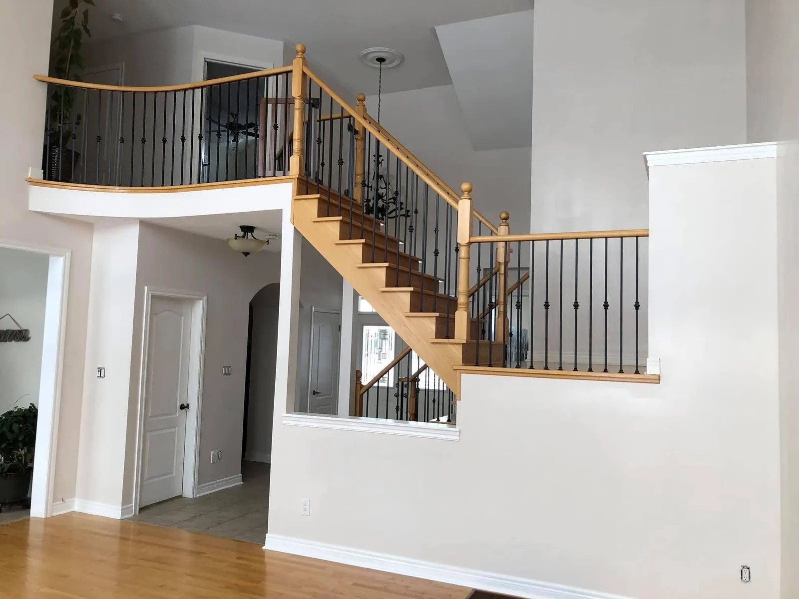 Staircase and balcony with black spindles and wood treads