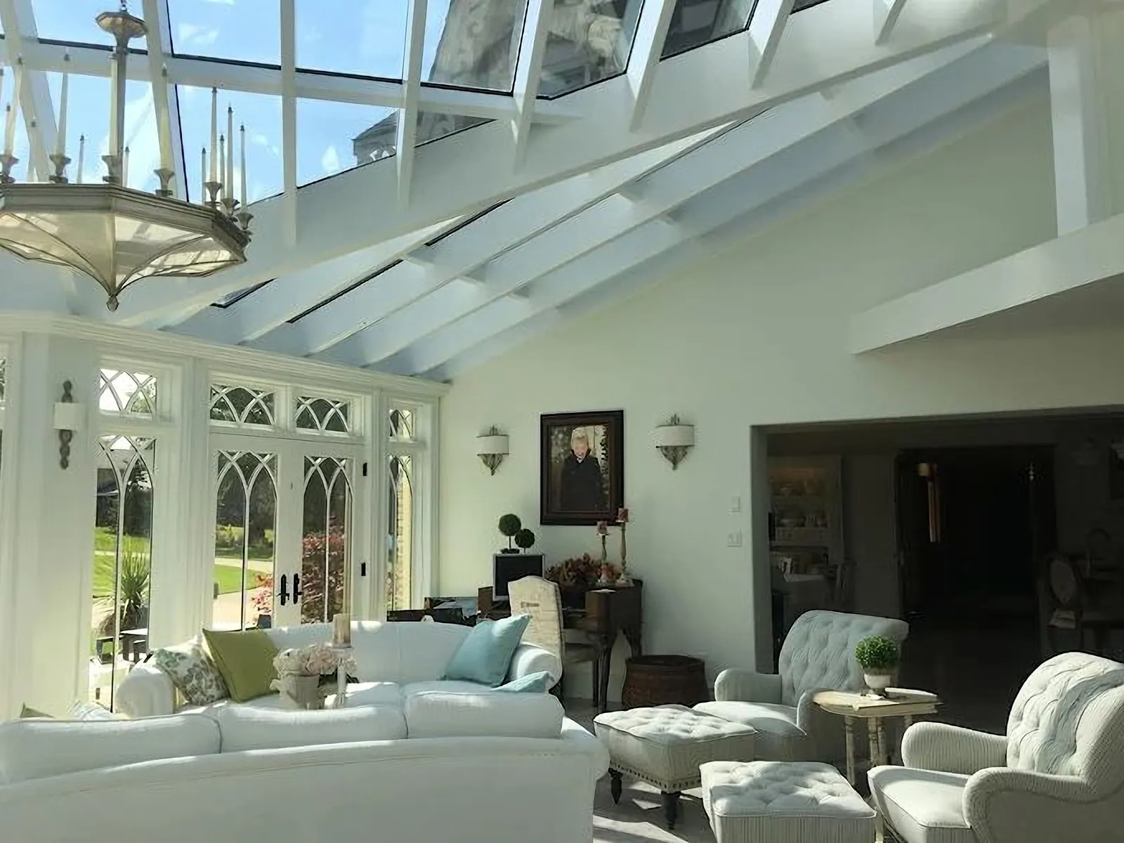 Sunroom with a glass roof and white painted trim