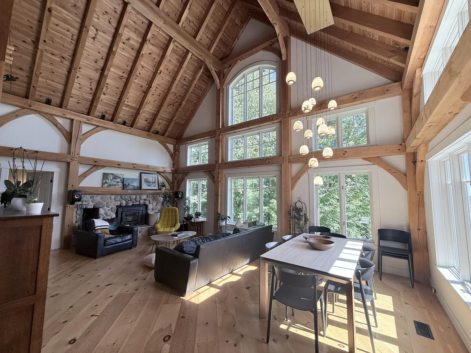Timber-frame living and dining space under a vaulted ceiling